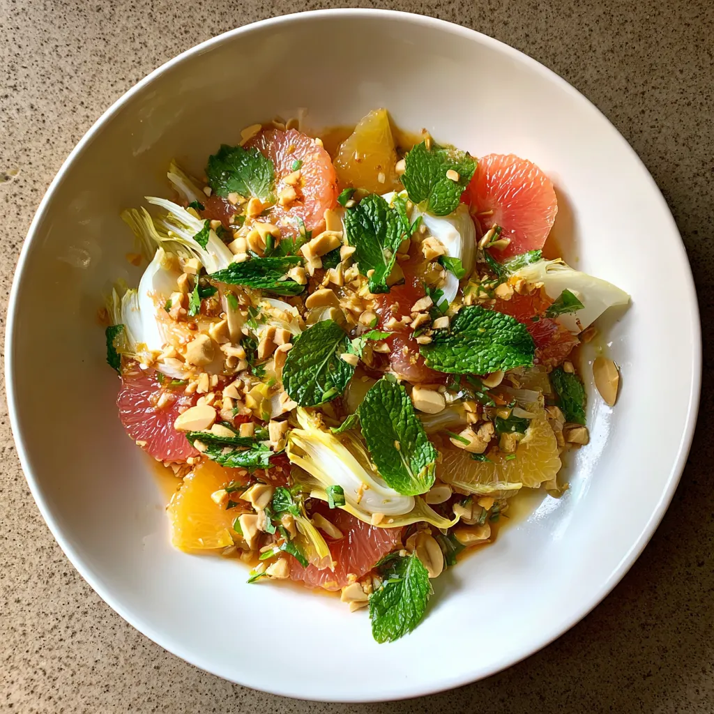 A white bowl filled with fruit and nuts.