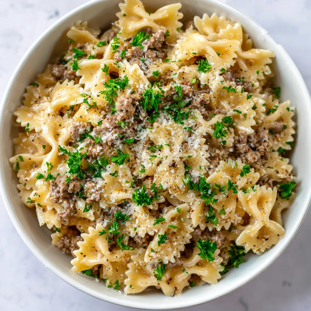 A bowl of pasta with meat and cheese.