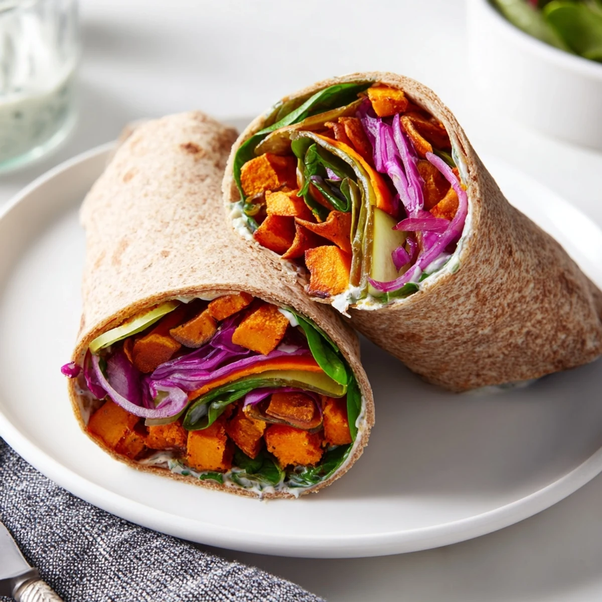 Roasted sweet potato and pickle chip wraps with fresh veggies and creamy sauce.