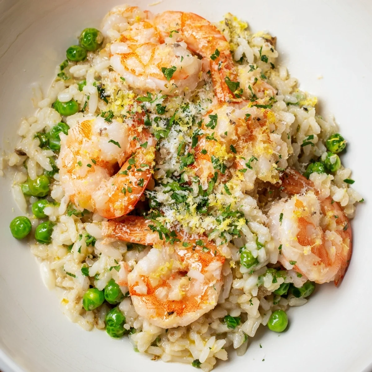 Juicy shrimp Parmesan rice skillet topped with fresh parsley and creamy cheese.