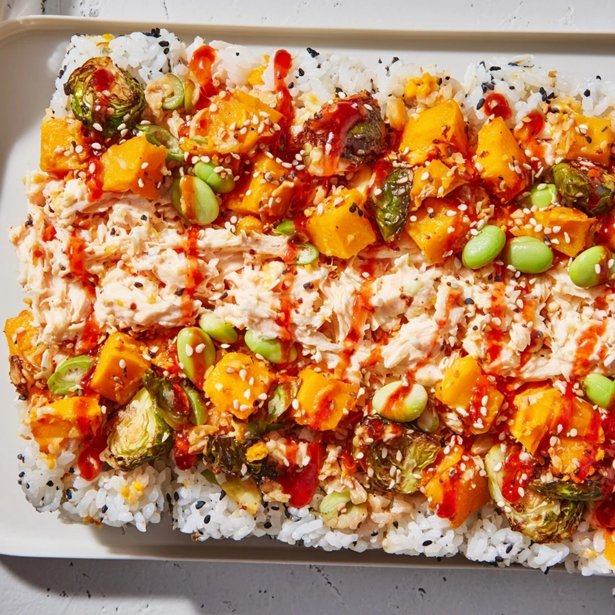 This delicious TikTok Viral Sushi Bake displays layers of sushi rice and topping off with sesame seeds.