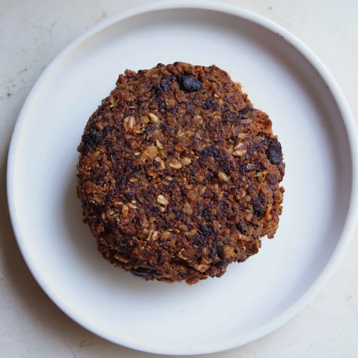 Crispy textured black bean burgers, packed with vegetables, ready for a satisfying, meat-free meal.