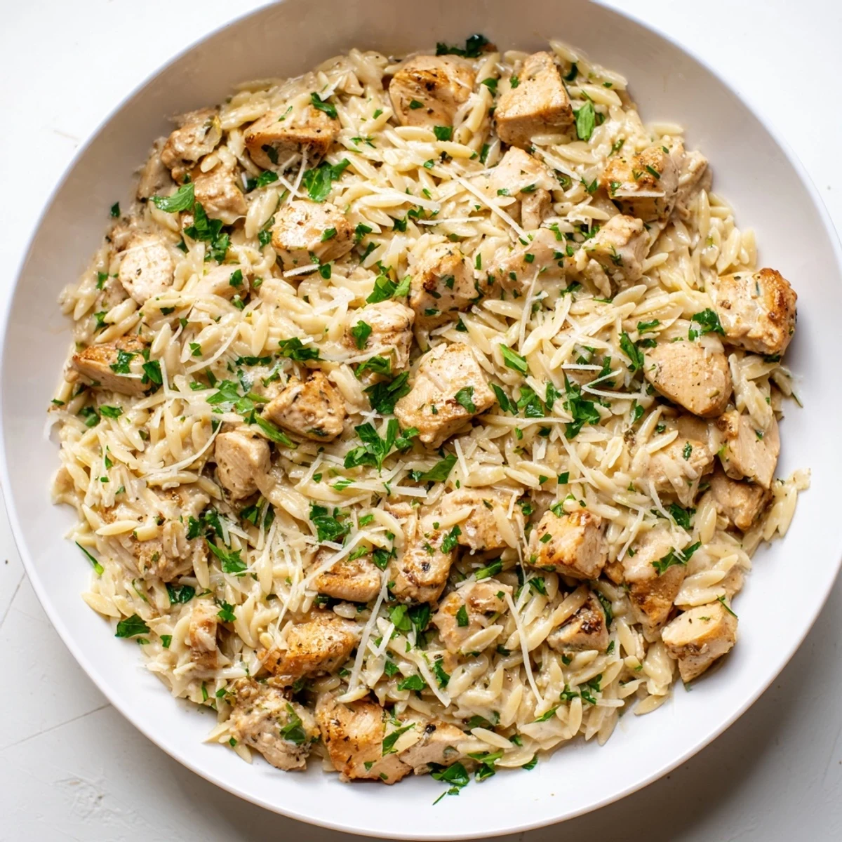 Garnish this One-Pot Cajun Chicken Alfredo Orzo with fresh parsley; a comforting weeknight delight.