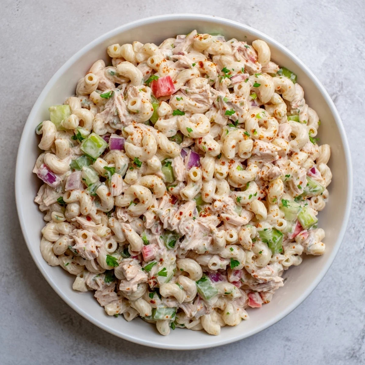 A creamy, chilled Chicken Macaroni Holiday Salad, filled with colorful veggies and a tangy dressing.