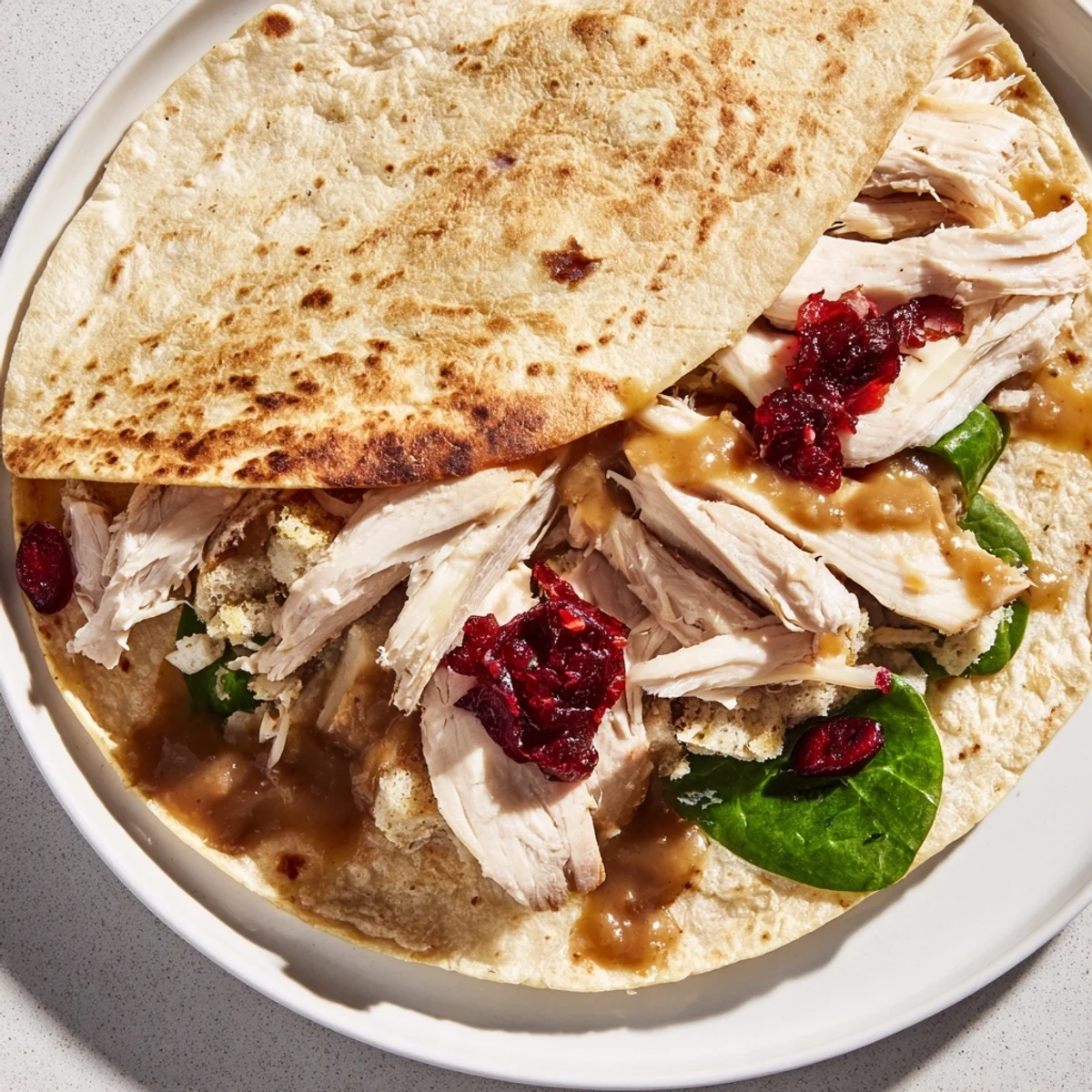 Tantalizing photo of a Moist Maker Chicken Wrap, showcasing warm, golden-brown tortilla and savory filling.