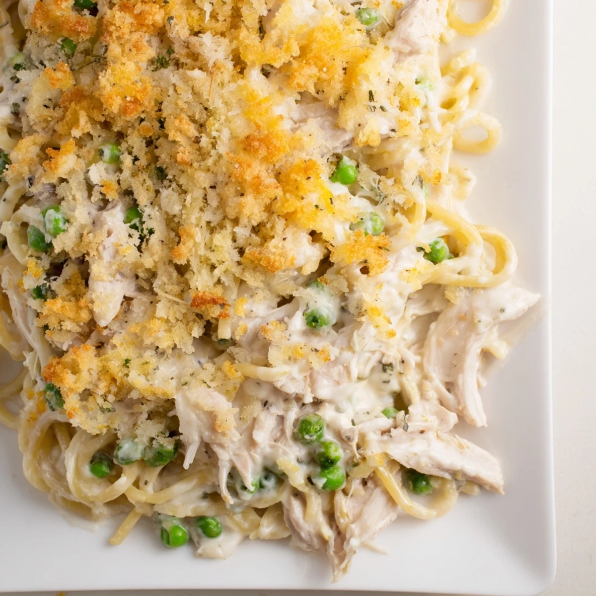 Golden, bubbly Turkey or Chicken Tetrazzini bake topped with parmesan and breadcrumbs, a comforting casserole.