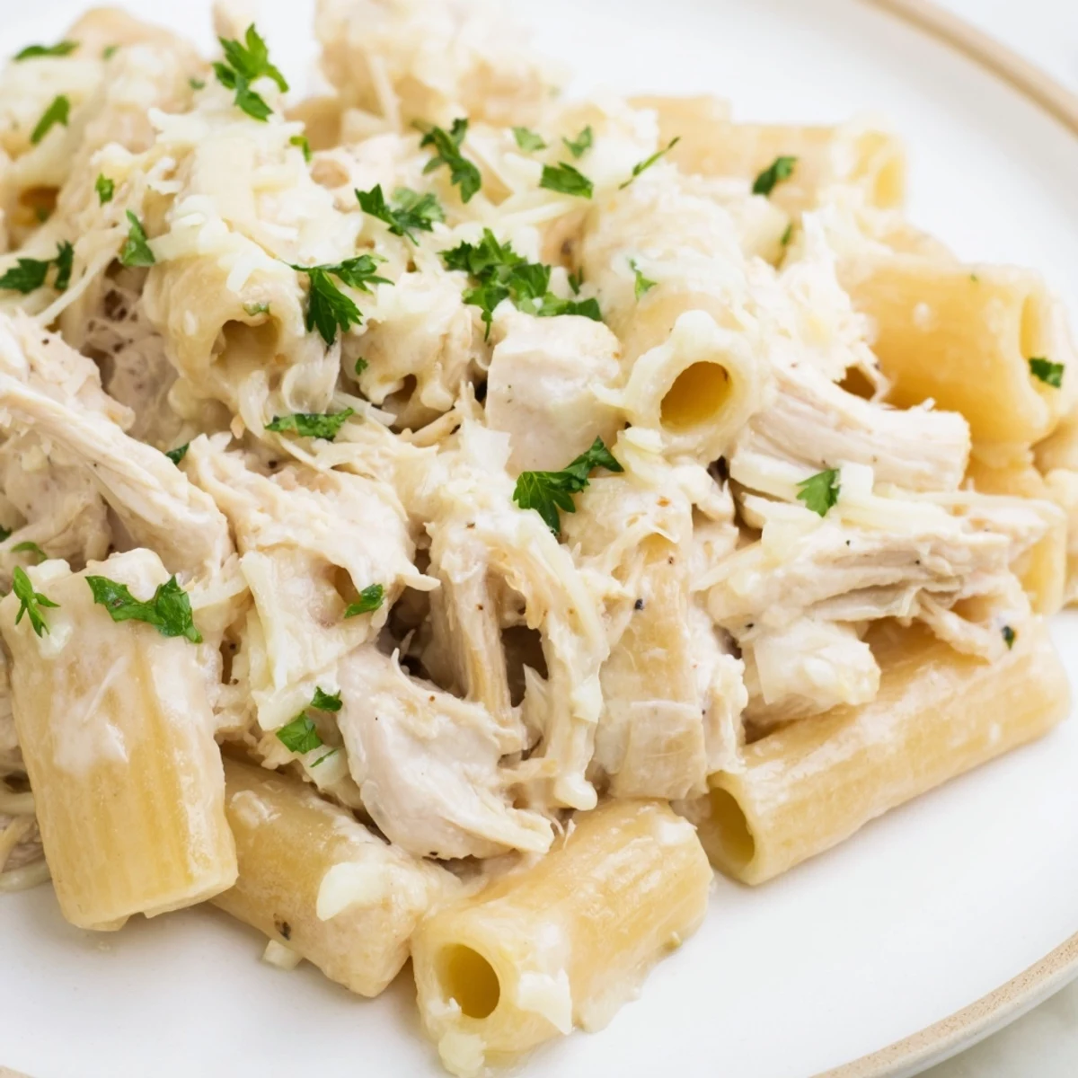 Slow cooker chicken Alfredo pasta bake, a creamy, bubbling casserole fresh from the oven, ready to serve.