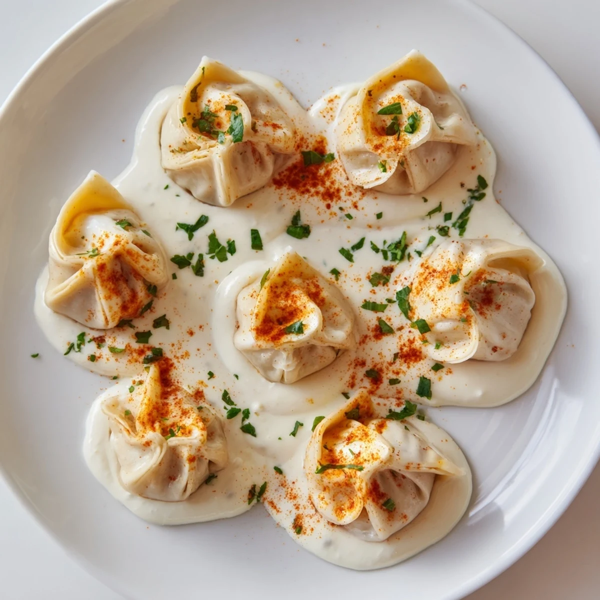 Delicious, freshly cooked Turkish cheesy manti, ready to be enjoyed with flavorful yogurt sauce.