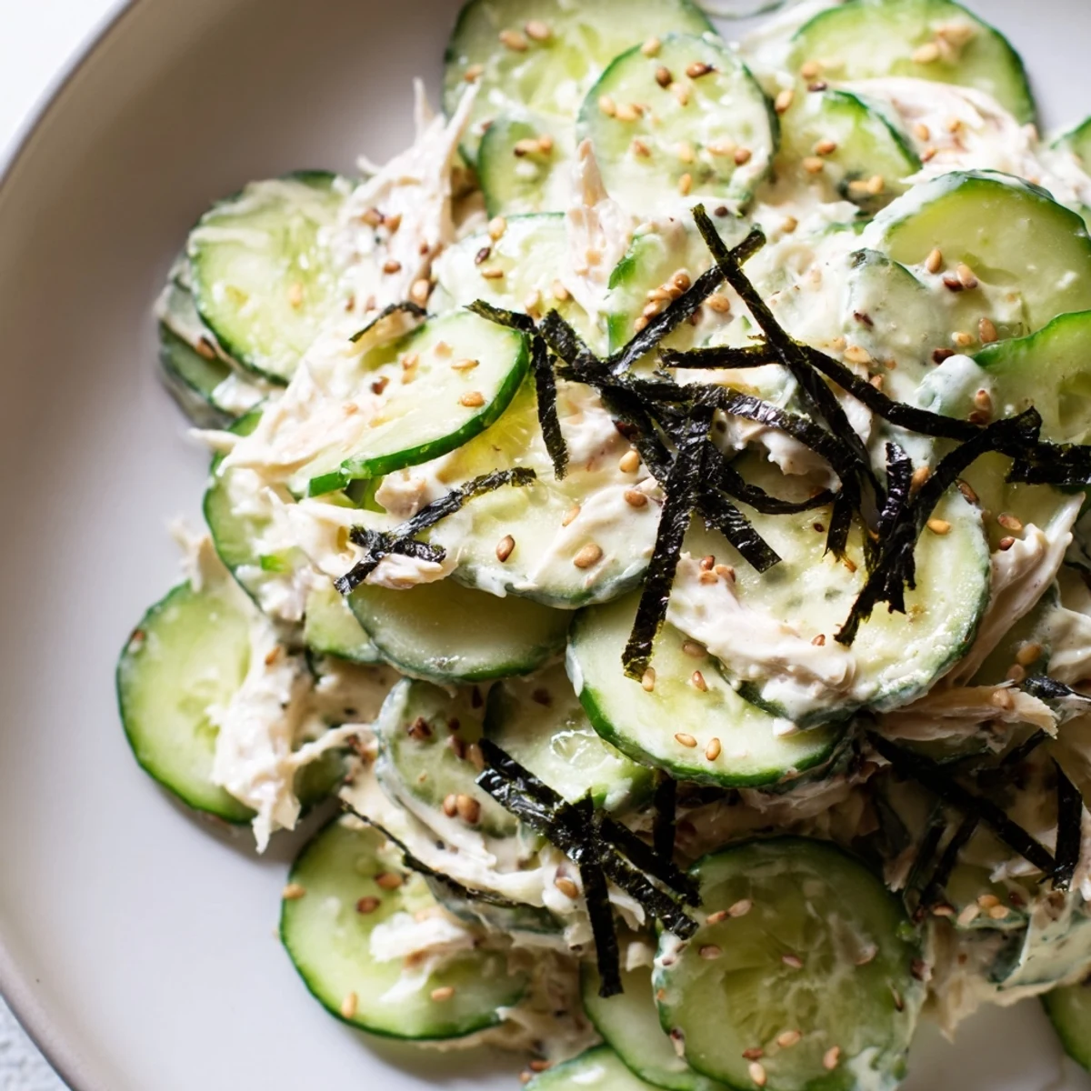 California Roll Cucumber Salad: A vibrant salad showing creamy, sliced cucumbers and crab, ready to enjoy.