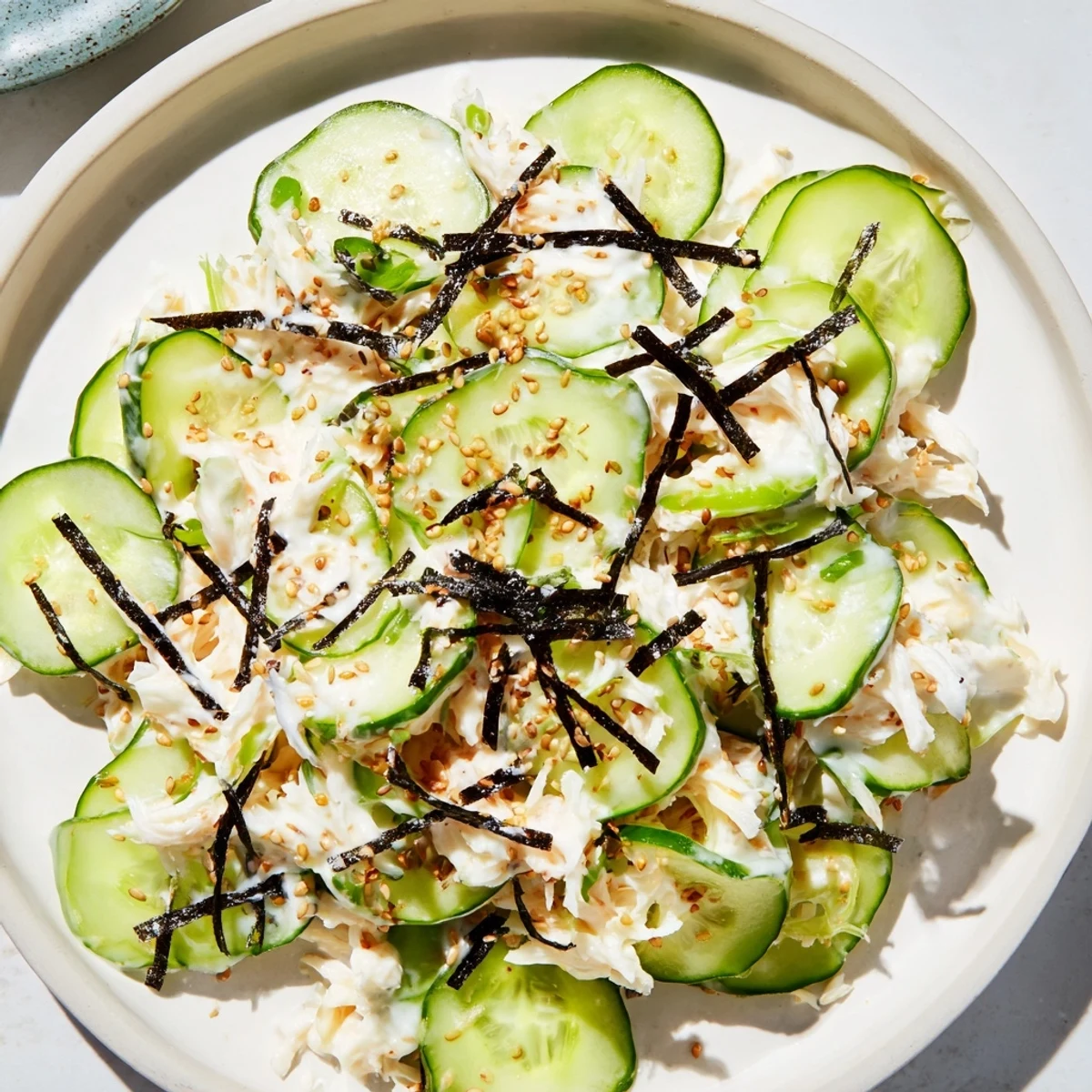 Fresh California Roll Cucumber Salad, served cold: See the colorful nori strips and sesame seeds sprinkled on top.