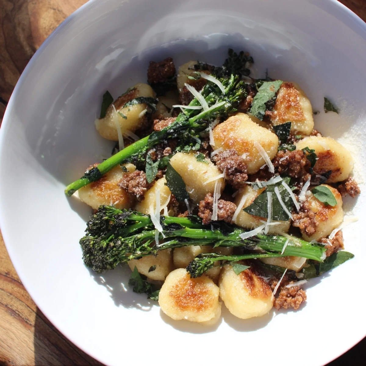Golden sheet pan gnocchi bake with crispy edges, sausage, and broccolini, ready to serve hot.