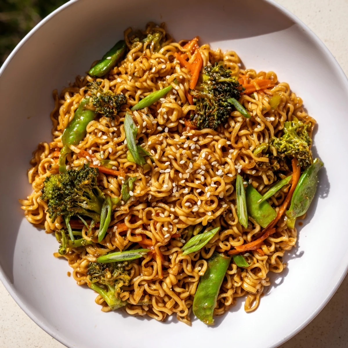 This flavorful Ramen Noodle Stir-Fry Remix shows perfectly cooked noodles with toasted sesame seeds and green onions.