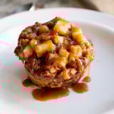 Delicious cinnamon-spiced muffins packed with caramelized apples, perfect for dessert lovers.