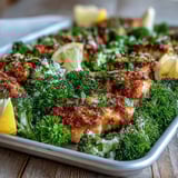 Roasted Crispy Parmesan Broccoli & Chicken Trays garnished with parsley and lemon wedges on the side.