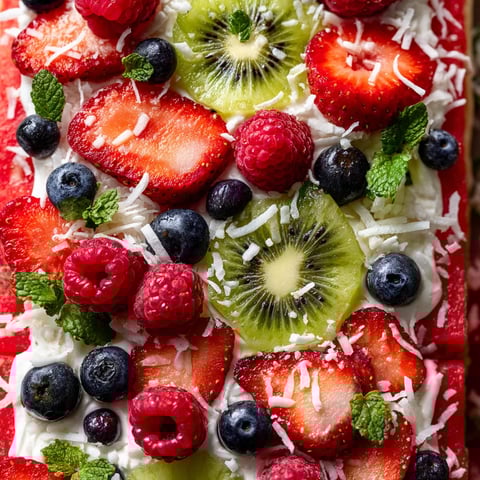 A slice of watermelon pizza with various fruits and vegetables on top.
