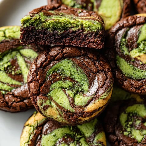 A plate of brownies with green swirls.