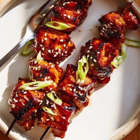 Grilled Ginger Teriyaki Chicken Skewers glistening with marinade, ready for a summer barbecue.