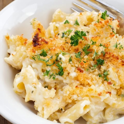 Creamy Alfredo Roasted Red Pepper Mac Cups with golden tops, perfect for gatherings.  