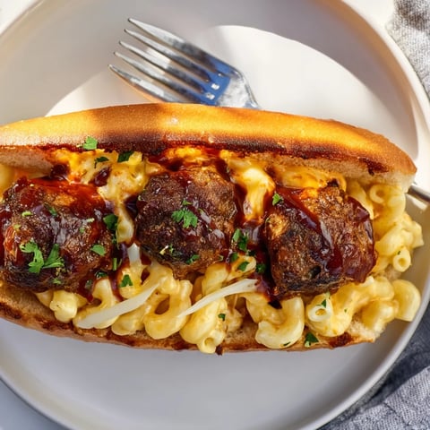 Savory Mac and Cheese BBQ Meatball Subs topped with mozzarella and fresh parsley.  