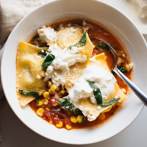 A vibrant bowl of Lasagne Soup with Sweet Corn Masala garnished with fresh herbs.  