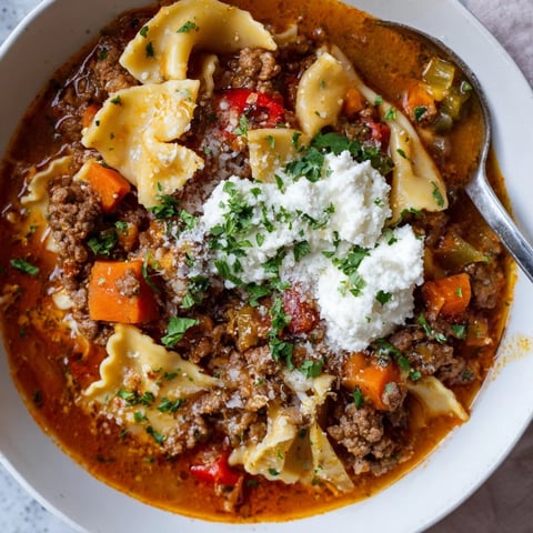 Creamy Lasagne Soup with Cheesy Jalapeño Twist, garnished with fresh parsley and jalapeños.  