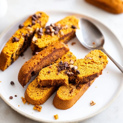 Crunchy pumpkin muffin biscotti dippers, perfect for dipping into steaming coffee.