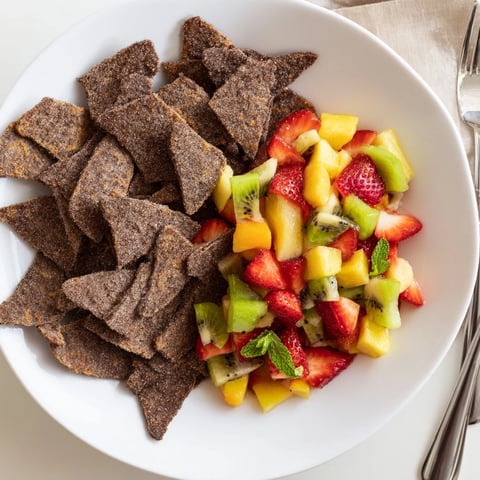 Crispy dessert chips and salsa with fresh fruit for a delightful treat.  