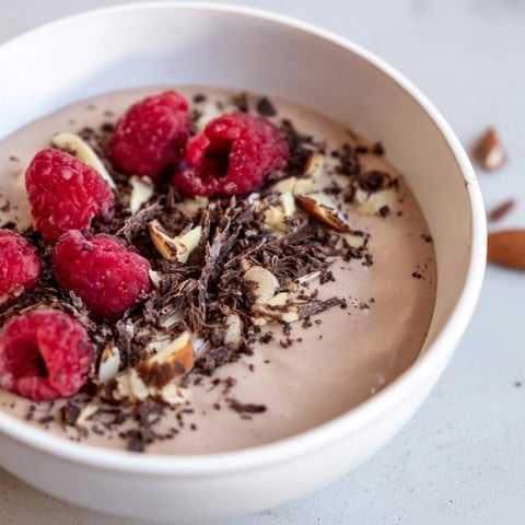 Smooth and creamy No-Bake Cottage Cheese Chocolate Mousse, ready to be topped with fresh berries.