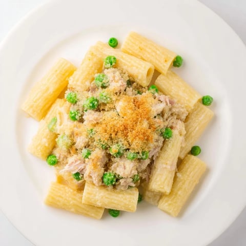 Golden, bubbly tuna pasta bake fresh out of the oven, topped with crispy breadcrumbs and cheese.