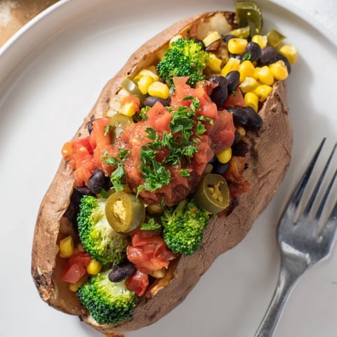 Steaming hot baked potato bar, loaded with cheddar, sour cream, and crispy bacon for a hearty meal.