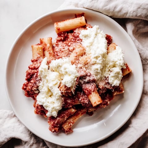 Steaming hot slow cooker baked ziti, bubbling with melted mozzarella and rich tomato sauce, ready to serve.