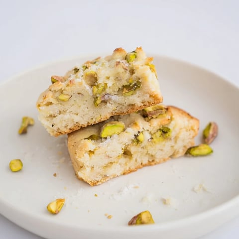 Golden, flaky Salted Pistachio Slice & Bake Shortbread cookies sprinkled with sea salt, ready for a treat.