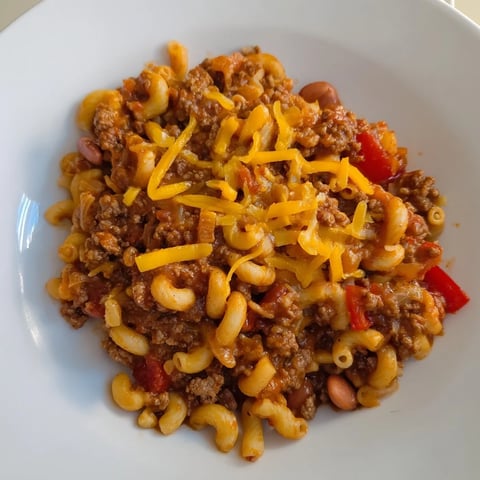 Cheesy, bubbling Cheeseburger Chili Mac Skillet, a one-pan meal with a perfectly melted cheese topping.