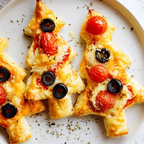 Golden-brown Puff Pastry Christmas Tree Pizza Bites, ready to enjoy with melted mozzarella cheese.
