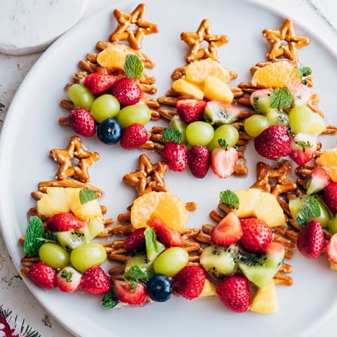 Fresh, colorful Ornament Fruit Medley arranged as festive Christmas ornaments, a healthy dessert treat.