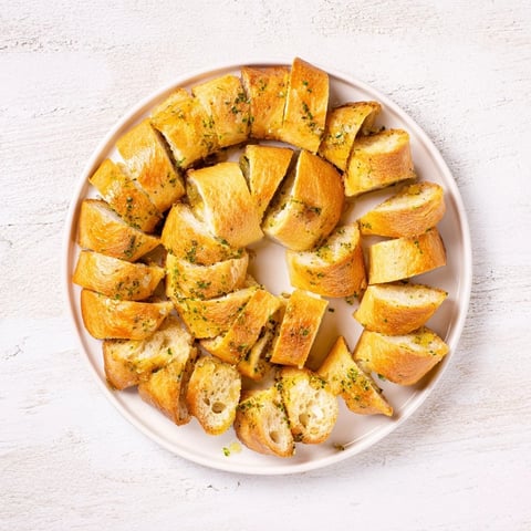 Golden, crisp baguette slices arranged in a circle, ready to complement your favorite appetizer dips.