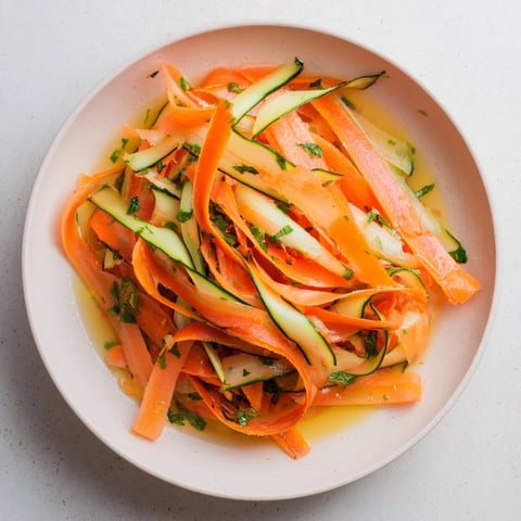 Bright Citrus Carrot Ribbon Salad with vibrant orange, yellow carrot ribbons and fresh herbs.