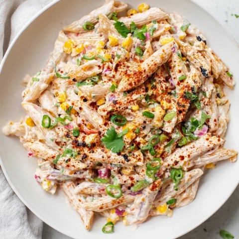 A close-up of creamy Mexican Street Corn Pasta, showcasing vibrant corn and fresh cilantro.
