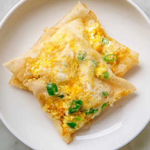 Golden, crispy Rice Paper Egg & Cheese Fold, a quick & easy breakfast snack with melted cheese.