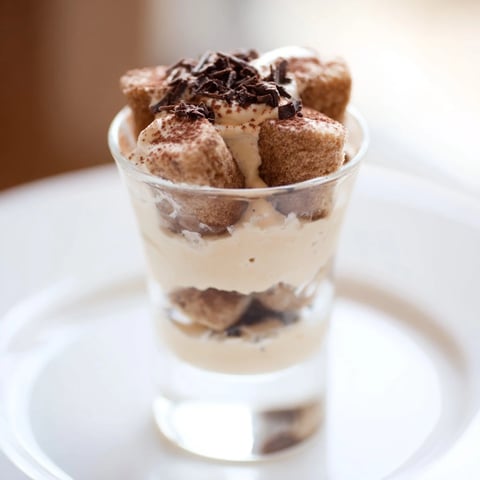 Deconstructed tiramisu shots, a sweet treat: layers of creamy mascarpone and espresso-soaked biscuits.
