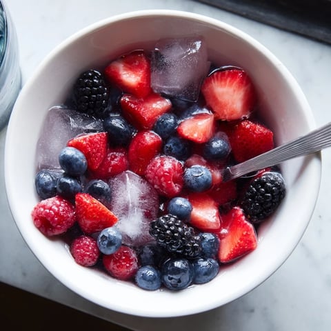 Vivid Nature's Cereal Bowl, overflowing with juicy berries in refreshing coconut water and ice.