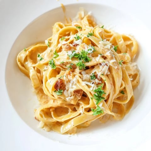 Golden strands of Sriracha Honey Pasta, coated in a creamy, glossy sauce, ready to serve and enjoy.