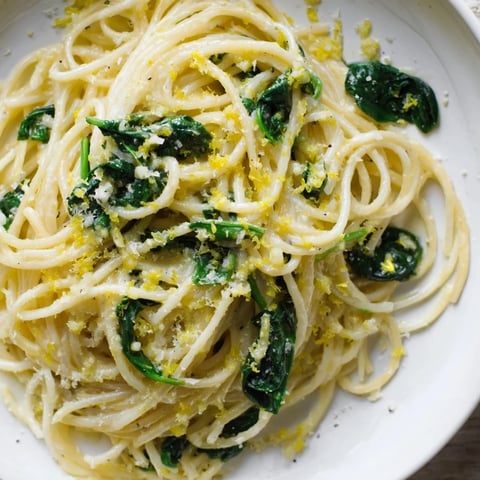 Steaming Creamy Lemon Spinach Spaghetti, tossed with vibrant spinach and Parmesan cheese, ready to eat!