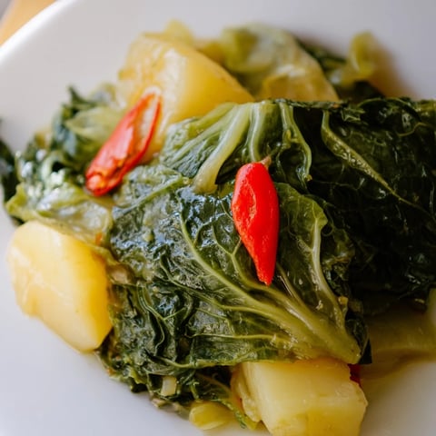 Tender cabbage and soft potatoes simmer in a fragrant chili broth, served steaming hot from the pot.