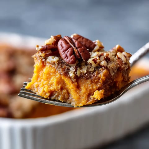 A fork with a piece of food on it.