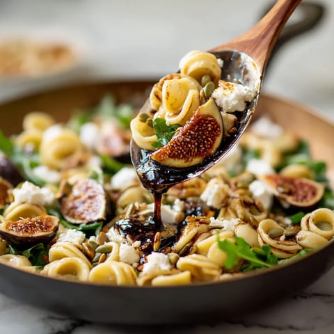 A wooden spoon is being used to scoop food from a bowl.