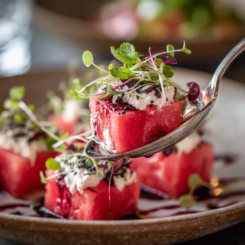 A slice of watermelon is being served on a plate.