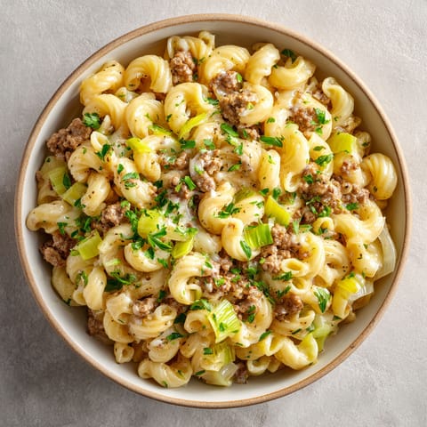 A bowl of beef macaroni with leeks.