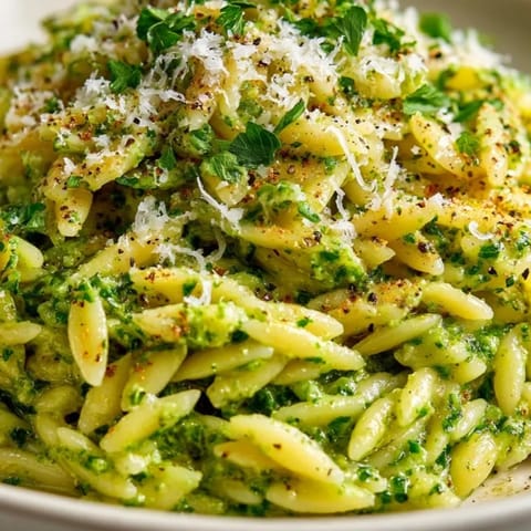Delicious Spinach Pesto Orzo recipe plated with Parmesan; a quick, flavorful vegetarian dinner.