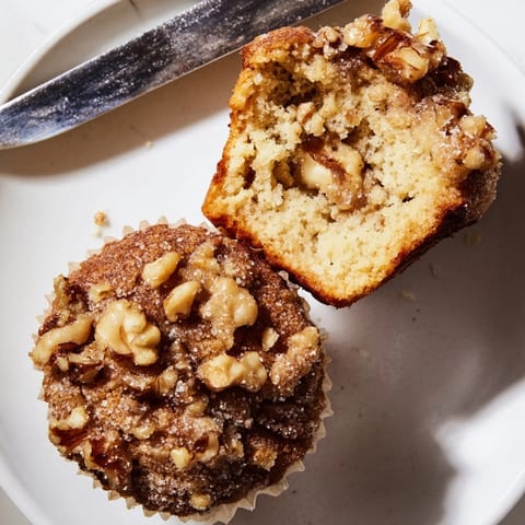 Warm, homemade Ricotta Walnut Crunch Muffins cooling on a rack, invitingly fragrant.